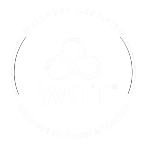 Circular 'Wellness Certified' badge for WITT with an infinity knot and border text reading 'Wellness in Travel & Tourism'.