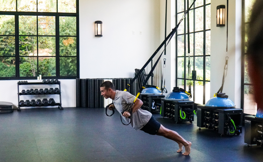 Man using TRX bands in a Fitness Studio at The Ranch Malibu