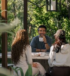 people drinking coffee around table 