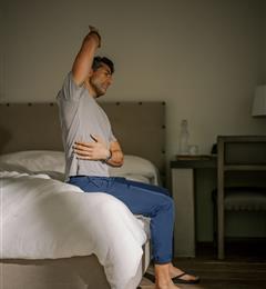 a man doing a stretch on bed 
