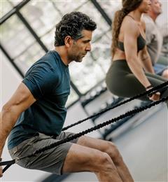 man working out with ropes