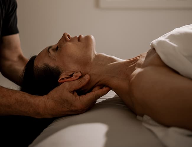 A woman receiving a neck massage