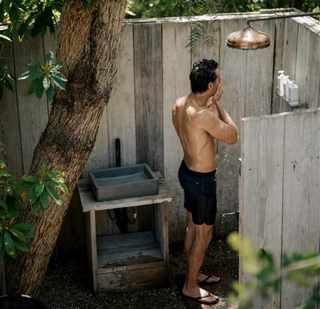 man in outdoor shower