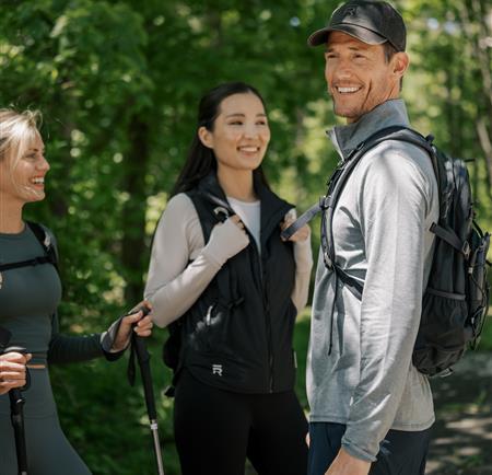 A group smiling while hiking together