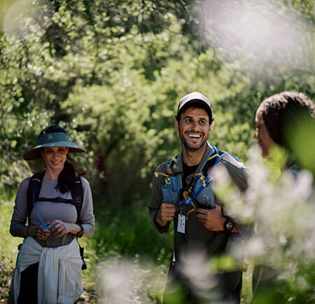 Group of people smiling together in hiking gear
