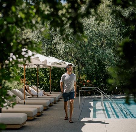 man walking by pool 