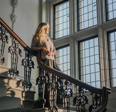 Woman relaxing on an ornate staircase in the sunshine