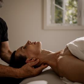 A woman receiving a massage outdoors