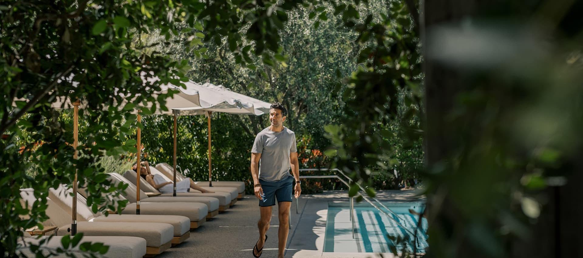 A man walking by the pool