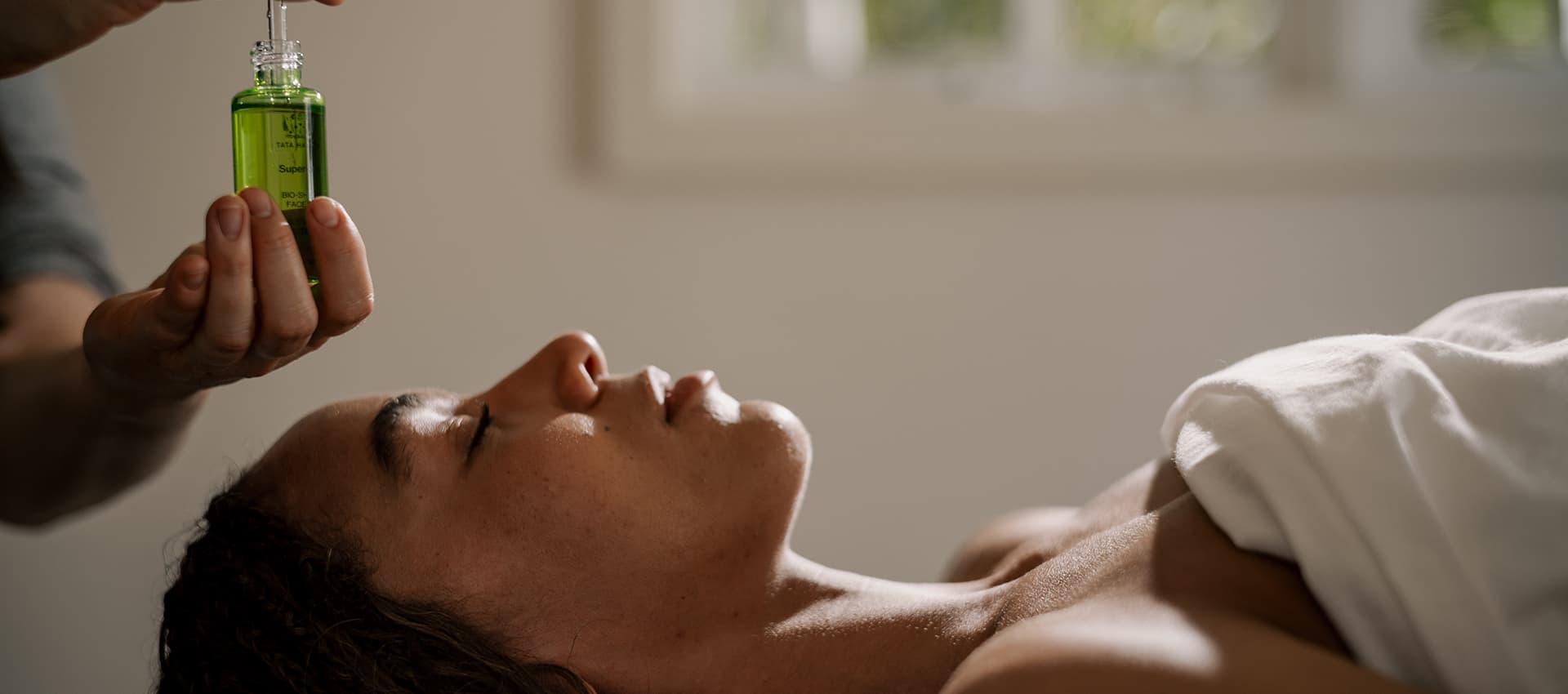 A woman receiving a facial
