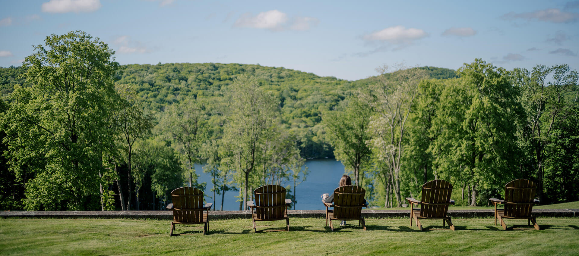 Woman sitting in a lawn chair overlooking the water