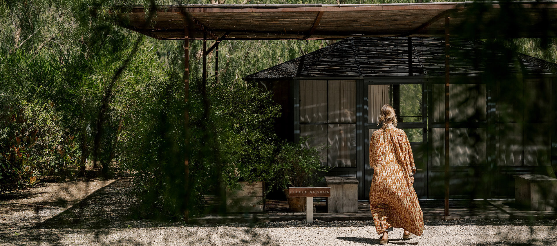 Woman walking to a building in an orange robe