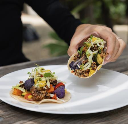 A person holding a taco