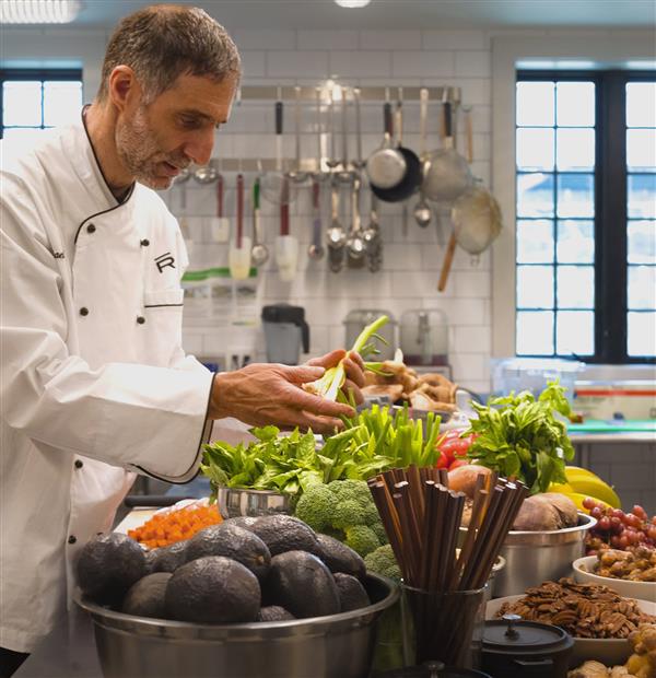 Two chefs cutting food